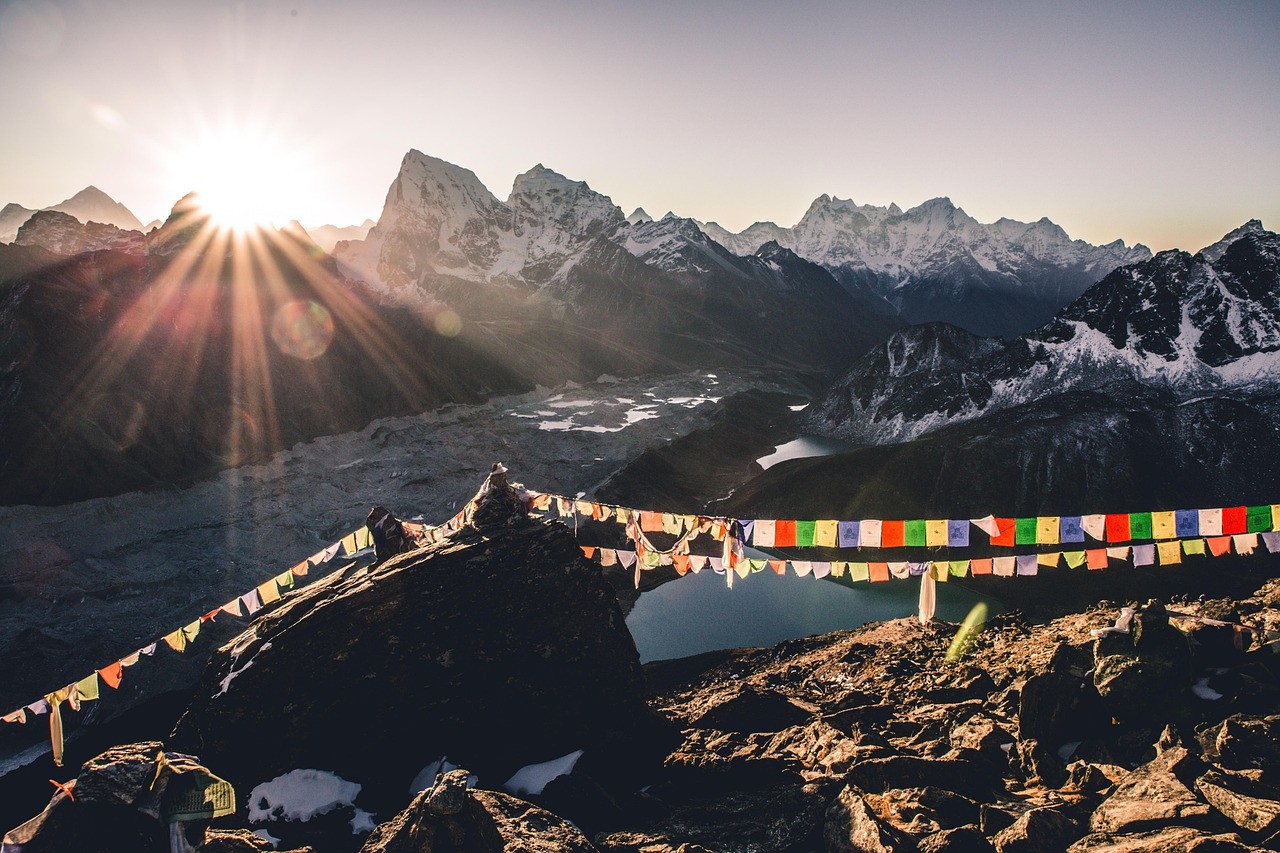 Sunrise over Gokyo Ri with prayer flags and glacier lakes below