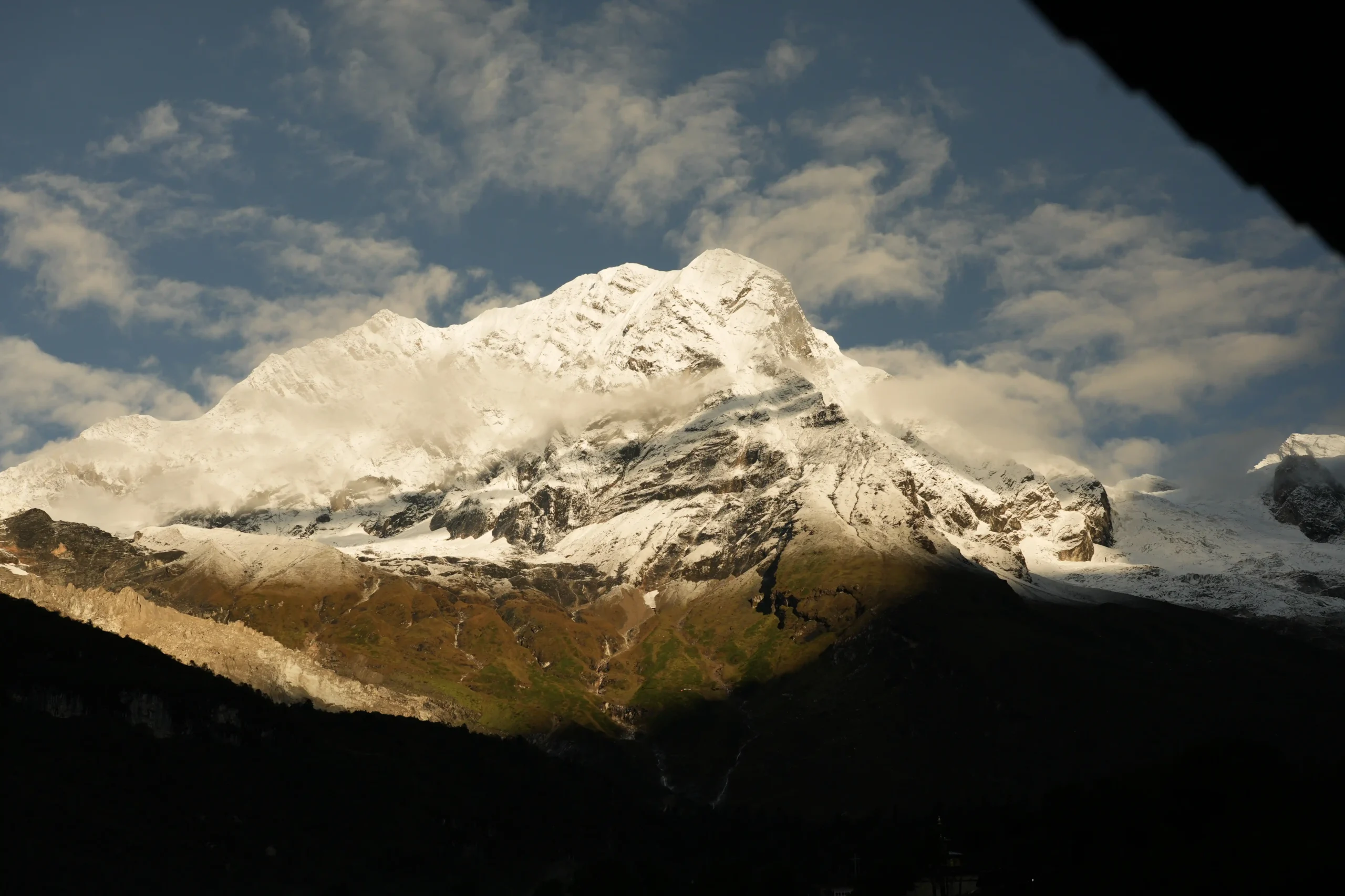 Golden light illuminating a massive Himalayan peak at sunset
